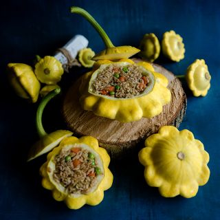 Stuffed Patisson Golden Marbre Scallop Summer Squash on a dark blue background.