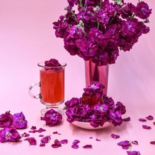 Chanter Alto Red Stock bouquet in pink vase with pink tea.