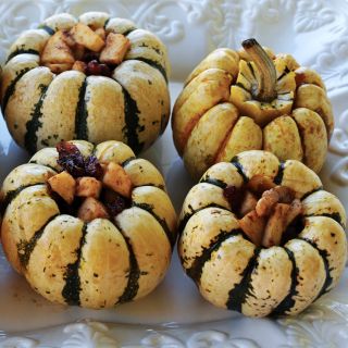 Stuffed Sweet Dumpling Winter Squash on a white plate.
