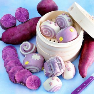 Lilac Beauty Sweet Potatoes and sweet steamed buns in a steamed on a light blue background.
