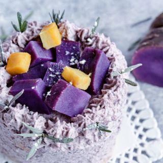 A lavender Lilac Beaty Sweet Potato cake on a light background.