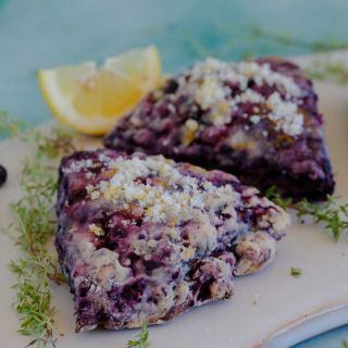 Orangelo Thyme on a plate with 2 black raspberry scones.
