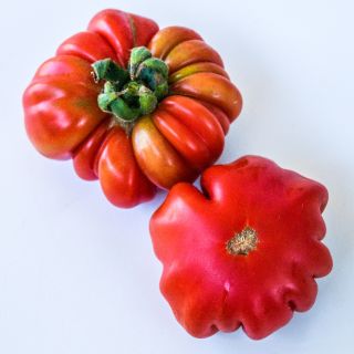 Two Burmese Sour Tomatoes on a white background.