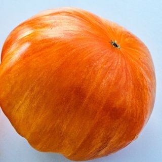 Close-up view of an Orange Jazz Tomato's striped skin.