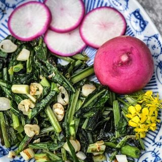 Hida Beni Red Turnip greens sauteed with garlic and garnished with fresh turnips.