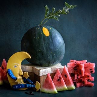 Moon and Stars Watermelon whole and sliced into star shapes with a wooden moon.