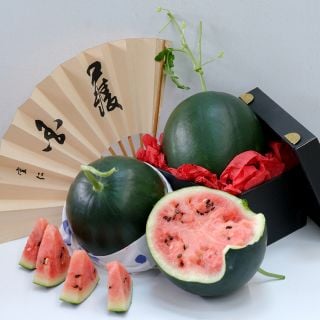 Black Jewel Watermelon, whole and halved with wedges and Oriental fan.